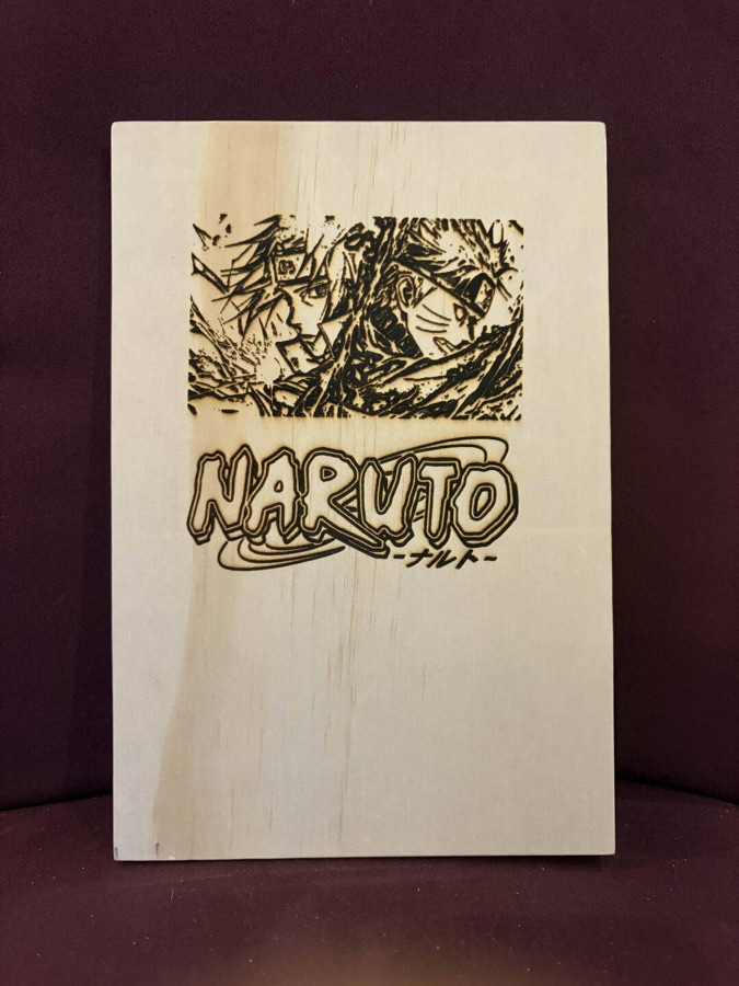 Engraved Naruto artwork and logo on a light wood board